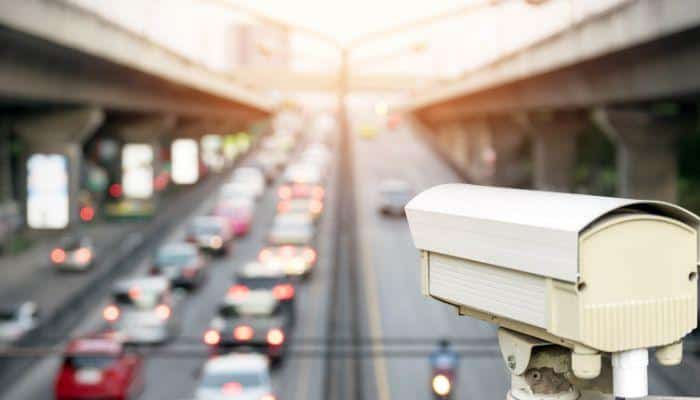 Surveillance camera monitoring cars as they pass by on a highway