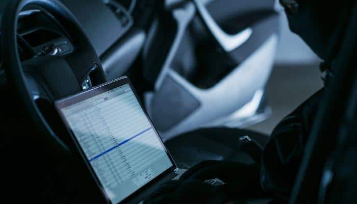 Hacker sitting in a car, intercepting traffic on a public wifi hotspot